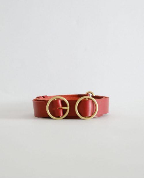 a leather belt with brass hardware